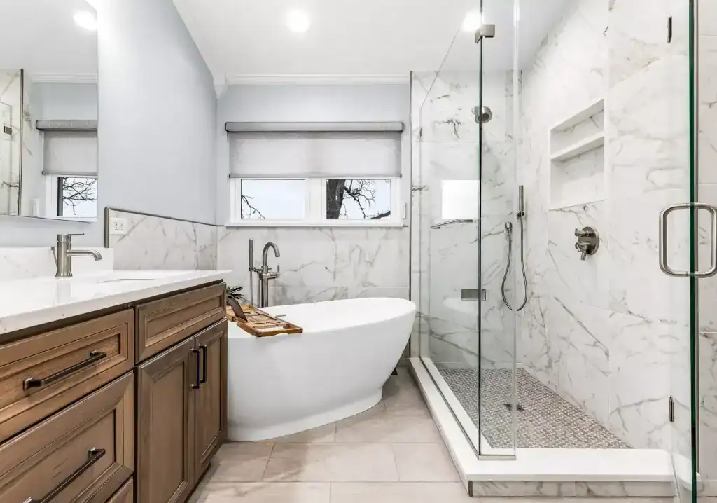 Kitchen and bath remodeling Lake County IL: Lindenhurst primary bath with a wood vanity, freestanding tub and marble-look glass shower