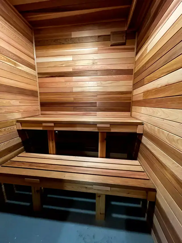 Custom basement sauna with cedar walls and two-level wood benches